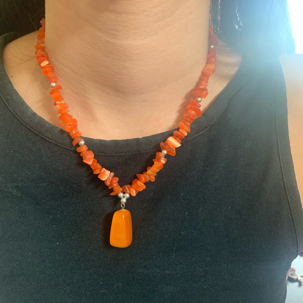 Women’s orange bead necklace with silver hardware
